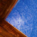 Uma Piscina Azul Com Um Deck De Madeira aiu57sP lrE